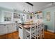 Bright, white kitchen featuring a butcher block island, open shelving, and modern pendant lighting at 813 Hudson Ave, Sarasota, FL 34236