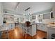 Open kitchen with a wooden island, white cabinets and eat-in breakfast bar at 813 Hudson Ave, Sarasota, FL 34236