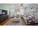 Bright living room featuring hardwood floors, dual couches, neutral rug and an entertainment center at 813 Hudson Ave, Sarasota, FL 34236
