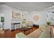 Cozy living room with fireplace, hardwood floors, comfortable seating and a decorative map at 813 Hudson Ave, Sarasota, FL 34236