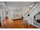 Spacious living room with hardwood floors, fireplace, and staircase with white wood paneling at 813 Hudson Ave, Sarasota, FL 34236