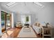 Airy living room showcasing skylights, neutral tones, and access to a balcony with tropical views at 813 Hudson Ave, Sarasota, FL 34236