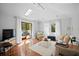 Bright living room features a skylight, french doors to a balcony, and comfortable seating at 813 Hudson Ave, Sarasota, FL 34236