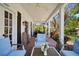 Charming covered patio with brick floors, ceiling fan, outdoor seating and views of the lush yard at 813 Hudson Ave, Sarasota, FL 34236