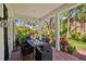 Inviting outdoor patio with lush landscaping, brick flooring, and dining area for entertaining at 813 Hudson Ave, Sarasota, FL 34236