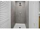 Modern shower with gray tile and sleek fixtures, providing a clean and contemporary bathing space at 813 Hudson Ave, Sarasota, FL 34236