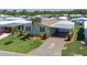 Overhead view of a well-maintained home with a spacious driveway, surrounded by lush greenery at 8424 Regal Way, Palmetto, FL 34221