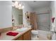 Bright bathroom features a vanity with sink and a bathtub with shower at 8424 Regal Way, Palmetto, FL 34221