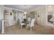 Elegant dining room with glass table, four upholstered chairs, and built in display shelves at 8424 Regal Way, Palmetto, FL 34221