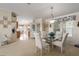 Inviting dining area featuring a glass table, four chairs, and sunny window with custom valance at 8424 Regal Way, Palmetto, FL 34221
