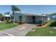Charming home with a well-manicured lawn and a decorative driveway at 8424 Regal Way, Palmetto, FL 34221