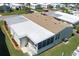 Aerial view of this single-story home featuring a screen enclosed porch and mature landscaping at 8424 Regal Way, Palmetto, FL 34221