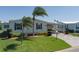 Inviting home with lush landscaping, mature trees, and a spacious driveway at 8424 Regal Way, Palmetto, FL 34221