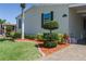 This charming home has mature, manicured landscaping with mulch beds and a paved driveway at 8424 Regal Way, Palmetto, FL 34221