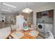 Bright kitchen with a utility closet featuring a washer and dryer next to the breakfast nook at 8424 Regal Way, Palmetto, FL 34221