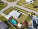Aerial view of a house with a fenced yard, an above-ground pool and mature trees at 8798 Herbison Ave, North Port, FL 34287