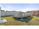 Backyard featuring an above-ground pool, bordered by grass and mulch, with a ladder at 8798 Herbison Ave, North Port, FL 34287