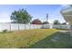 Expansive backyard with a white fence, storage shed, and an above-ground pool setup at 8798 Herbison Ave, North Port, FL 34287