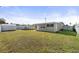 Large backyard showing the house, an above ground pool, a storage shed and an expanse of grass at 8798 Herbison Ave, North Port, FL 34287