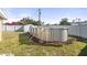 View of above-ground pool in backyard with a white fence, storage shed, and lush greenery at 8798 Herbison Ave, North Port, FL 34287