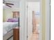 View from bedroom into a bathroom, featuring a tub and shower combination and tile floors at 8798 Herbison Ave, North Port, FL 34287