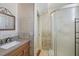 Well-lit bathroom with a granite vanity and a modern shower at 8798 Herbison Ave, North Port, FL 34287