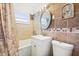 Charming bathroom with a white vanity, modern fixtures, and attractive tile work at 8798 Herbison Ave, North Port, FL 34287