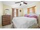 Relaxing bedroom featuring a bed, a wooden dresser, and neutral color scheme throughout at 8798 Herbison Ave, North Port, FL 34287