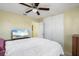 Bedroom with a ceiling fan, closet, a mounted TV, and neutral color scheme throughout at 8798 Herbison Ave, North Port, FL 34287