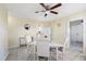 Bright dining room features modern ceiling fan, neutral tones, and a sleek tile floor at 8798 Herbison Ave, North Port, FL 34287