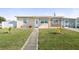 Inviting single-story home with a well-manicured lawn and quaint facade at 8798 Herbison Ave, North Port, FL 34287