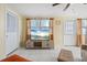 Cozy living room featuring tile floors, neutral walls, and a flat-screen television with beach scene at 8798 Herbison Ave, North Port, FL 34287