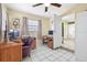Well-lit office space featuring a wooden desk, computer setup, tile floors, and neutral walls at 8798 Herbison Ave, North Port, FL 34287