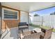 Covered patio with outdoor seating and a view of the fenced backyard, ideal for relaxing at 8798 Herbison Ave, North Port, FL 34287