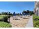 Enjoy outdoor dining on the clubhouse patio with tables, chairs, and blue umbrellas overlooking the golf course at 9620 Club South Cir # 5306, Sarasota, FL 34238