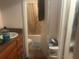 Bathroom including a single vanity, toilet, and shower and tub combo at 965 Whitman Dr, Sarasota, FL 34243