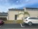 Two-story tan townhouse with a palm tree in the front yard at 965 Whitman Dr, Sarasota, FL 34243