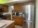 Kitchen featuring stainless steel refrigerator and a pantry at 965 Whitman Dr, Sarasota, FL 34243