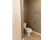 View of a half bathroom with a toilet, towel rack, toilet paper holder, and tiled flooring at 5691 Bentgrass Dr # 15-102, Sarasota, FL 34235