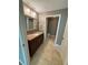 Bathroom featuring vanity with sink, mirror and tile floors at 5691 Bentgrass Dr # 15-102, Sarasota, FL 34235