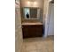 Bathroom with a granite countertop, dark wood vanity, and tile floor at 5691 Bentgrass Dr # 15-102, Sarasota, FL 34235