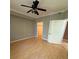 Bedroom boasts laminate wood flooring, ceiling fan, and a closet at 5691 Bentgrass Dr # 15-102, Sarasota, FL 34235