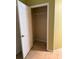 A walk-in closet with tile flooring, wire shelving, and an open white door at 5691 Bentgrass Dr # 15-102, Sarasota, FL 34235