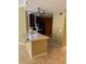 An open kitchen with dark cabinets, stainless hood, light countertops and track lighting at 5691 Bentgrass Dr # 15-102, Sarasota, FL 34235