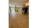 Open concept living room with tiled flooring, fan, and sliding door to screened porch at 5691 Bentgrass Dr # 15-102, Sarasota, FL 34235