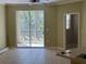 Living room and kitchen with ceramic tile and access to screened balcony at 5691 Bentgrass Dr # 15-102, Sarasota, FL 34235