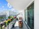 Balcony features city views, potted flowers, seating, and sliding glass doors at 101 S Gulfstream Ave. # 9C, Sarasota, FL 34236