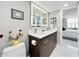 This bathroom boasts modern vanity, dual sinks, quartz countertop, and contemporary lighted mirror at 101 S Gulfstream Ave. # 9C, Sarasota, FL 34236