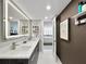 Modern bathroom features illuminated mirror, double vanity and granite countertop at 101 S Gulfstream Ave. # 9C, Sarasota, FL 34236