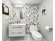Modern half-bathroom featuring a contemporary vanity and stylish patterned wall at 101 S Gulfstream Ave. # 9C, Sarasota, FL 34236